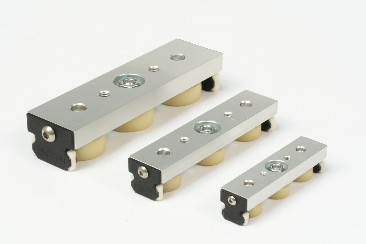 Three sizes of UtiliTrak wheel plate assemblies with polymer crowned rollers.