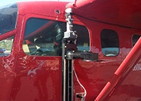 An XLA actuator mounted vertically on the outside of a small red airplane.